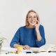 cheerful-young-female-teacher-in-eyewear-sits-at-w-2021-08-31-05-42-11-utc.jpg